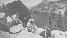Trail Blazers sitting above an alpine lake